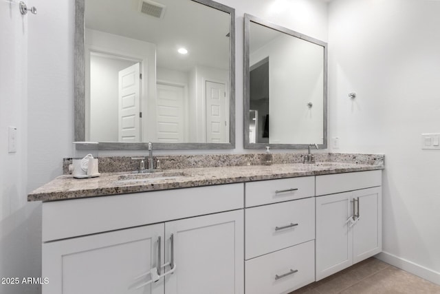5897 N 195th Dr, Litchfield Park, AZ 85340 - bathroom featuring baseboards, double vanity, and tile patterned floors