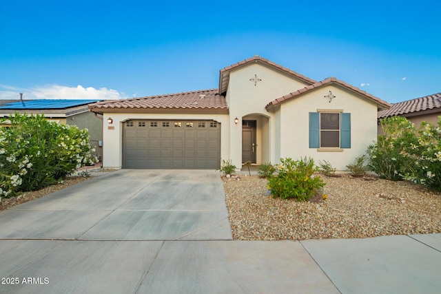 5897 N 195th Dr, Litchfield Park, AZ 85340 - mediterranean / spanish house featuring an attached garage, stucco siding, a tile roof, and concrete driveway