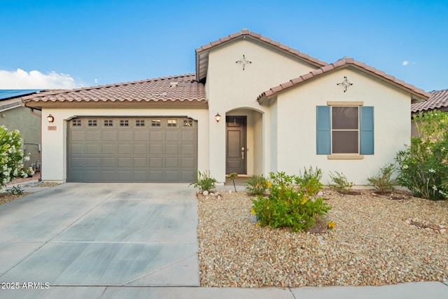 5897 N 195th Dr, Litchfield Park, AZ 85340 - mediterranean / spanish-style home with a garage, driveway, a tiled roof, and stucco siding