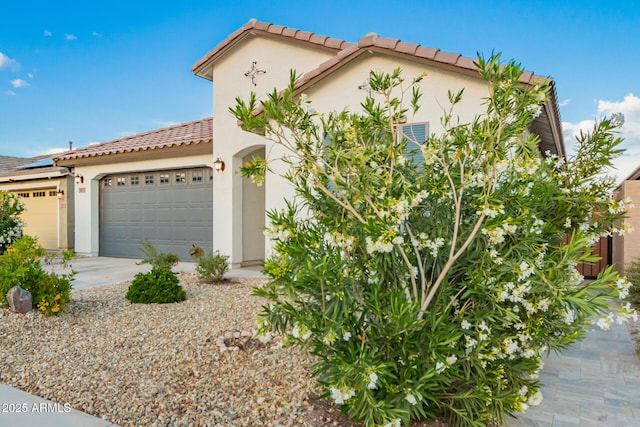 5897 N 195th Dr, Litchfield Park, AZ 85340 - mediterranean / spanish-style house featuring stucco siding, a tiled roof, an attached garage, and driveway