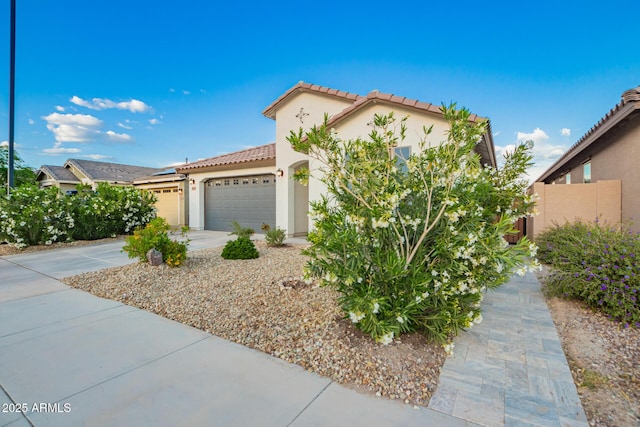 5897 N 195th Dr, Litchfield Park, AZ 85340 - mediterranean / spanish house with a tiled roof, stucco siding, an attached garage, and concrete driveway