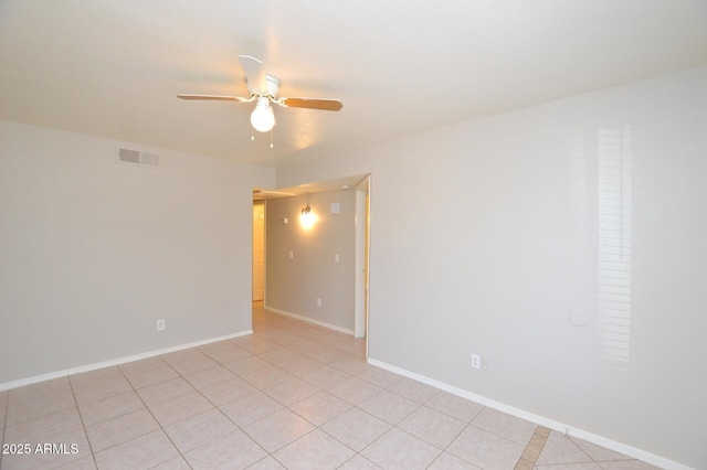 tiled empty room with ceiling fan