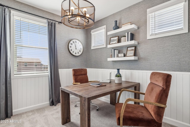 carpeted office featuring an inviting chandelier and plenty of natural light