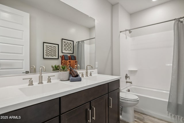 full bathroom with vanity, hardwood / wood-style floors, shower / bathtub combination with curtain, and toilet