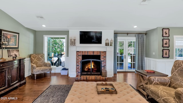 living room with french doors, a fireplace, and dark hardwood / wood-style flooring