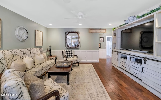 living room featuring ceiling fan and dark hardwood / wood-style flooring