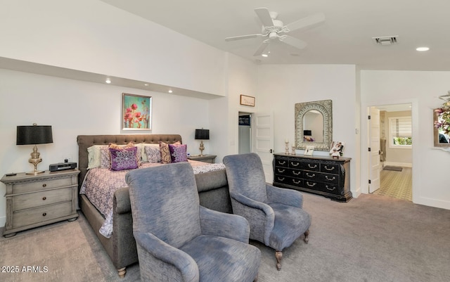 carpeted bedroom featuring ceiling fan, ensuite bathroom, and vaulted ceiling