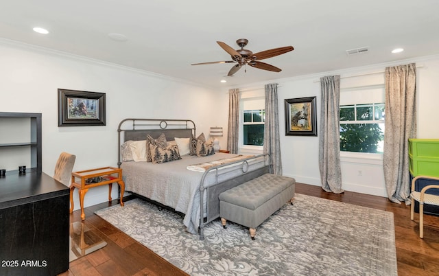 bedroom with ceiling fan, dark wood-type flooring, and crown molding