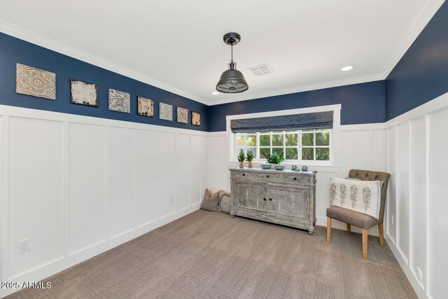 living area featuring ornamental molding and carpet floors