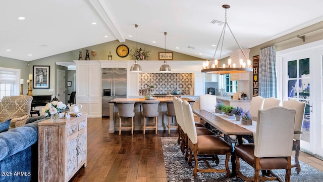 dining space with dark hardwood / wood-style flooring, a chandelier, and lofted ceiling with beams