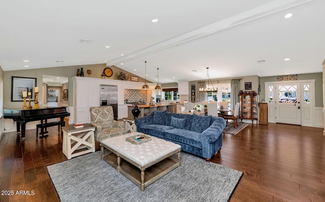 living room featuring dark wood-type flooring and vaulted ceiling with beams