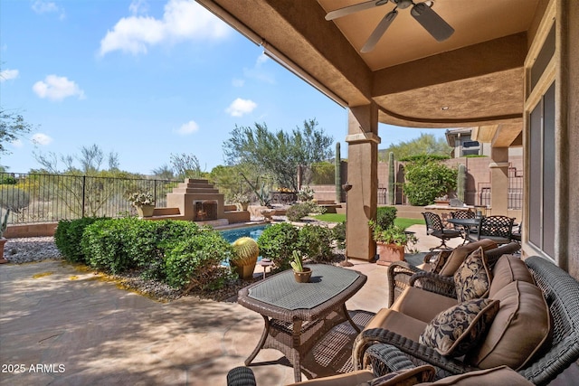 41910 N Long Cove Way, Anthem, AZ 85086 - view of patio / terrace featuring a ceiling fan, an outdoor living space with a fireplace, and fence