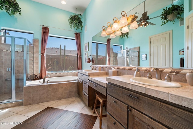 41910 N Long Cove Way, Anthem, AZ 85086 - full bathroom with a bath, vanity, a high ceiling, a stall shower, and tile patterned floors