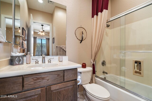 41910 N Long Cove Way, Anthem, AZ 85086 - bathroom with ceiling fan, shower / bath combination with glass door, vanity, visible vents, and toilet