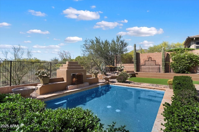 41910 N Long Cove Way, Anthem, AZ 85086 - view of pool with fence and a warm lit fireplace