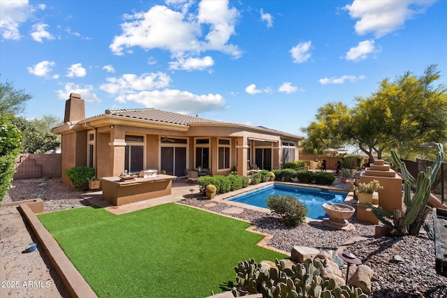 41910 N Long Cove Way, Anthem, AZ 85086 - back of house with a patio area, a chimney, a fenced backyard, stucco siding, and a fenced in pool