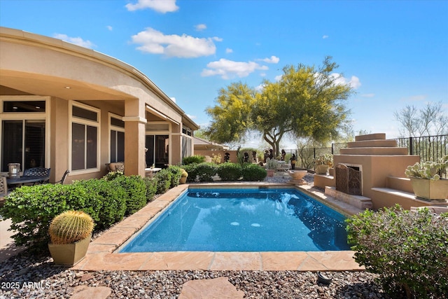 41910 N Long Cove Way, Anthem, AZ 85086 - view of swimming pool featuring a fenced in pool, exterior fireplace, and fence