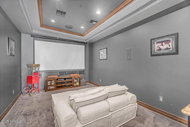 cinema room with a raised ceiling, baseboards, and visible vents