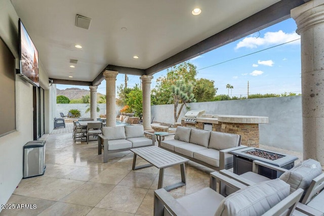view of patio / terrace with an outdoor living space with a fire pit, outdoor dining space, fence, and area for grilling