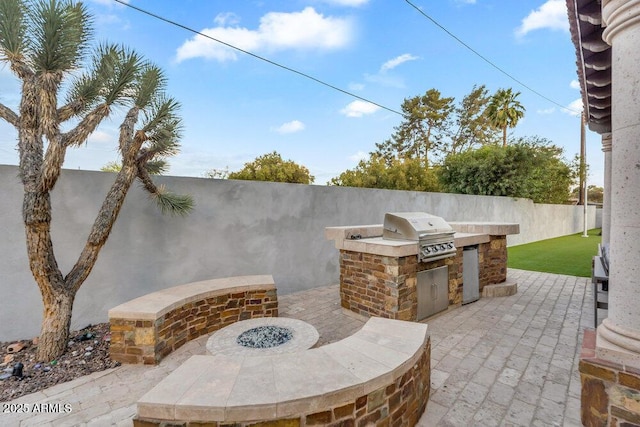 view of patio / terrace featuring a grill, area for grilling, and fence