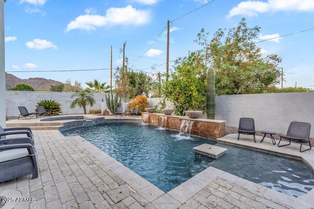 view of pool with a patio area, a fenced backyard, and a pool with connected hot tub