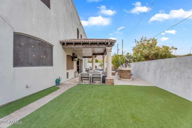 view of yard with outdoor lounge area, a patio area, and fence