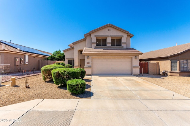 view of front of house with stucco siding, a garage, concrete driveway, fence, and a tile roof