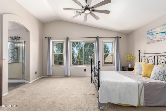bedroom with vaulted ceiling, carpet floors, baseboards, arched walkways, and a ceiling fan