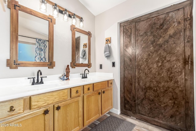 bathroom featuring double vanity and curtained shower
