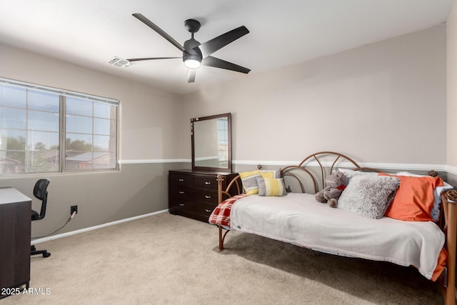 carpeted bedroom with multiple windows, baseboards, a ceiling fan, and a desk