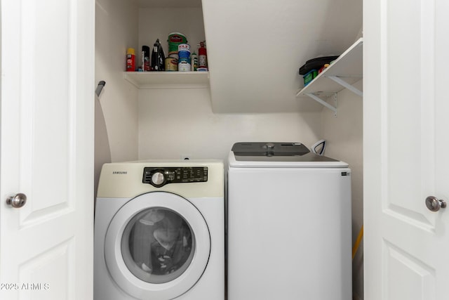 laundry area with washing machine and clothes dryer