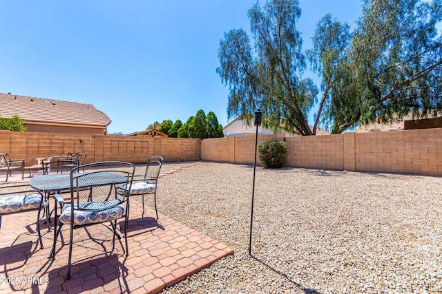 view of patio featuring a fenced backyard and outdoor dining space