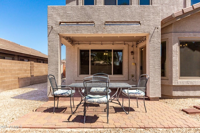 view of patio / terrace featuring fence and outdoor dining area