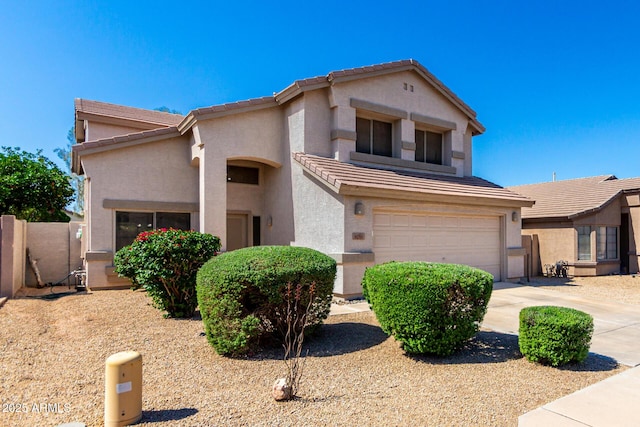 view of front facade with a tiled roof, a garage, stucco siding, concrete driveway, and fence