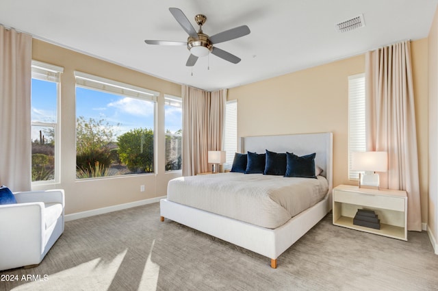 bedroom with light carpet and ceiling fan