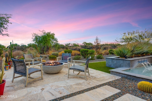 patio terrace at dusk with a fire pit