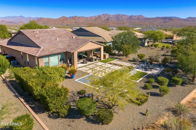 birds eye view of property with a mountain view