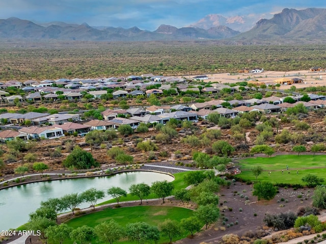 birds eye view of property with a water and mountain view