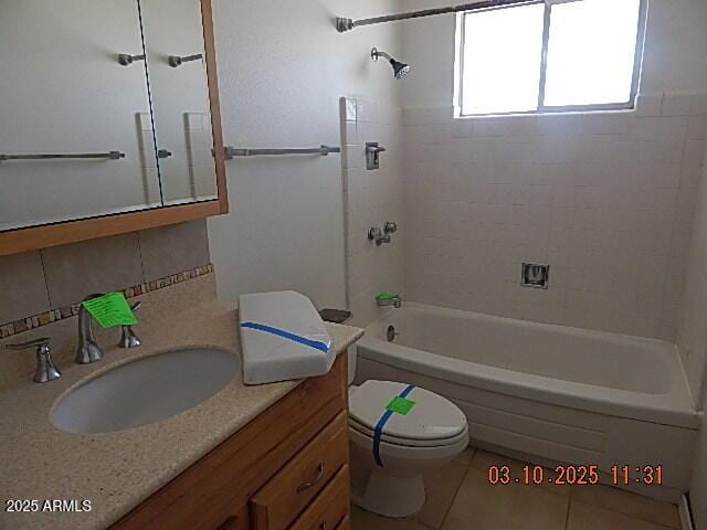 bathroom featuring vanity, tub / shower combination, tile patterned flooring, toilet, and backsplash