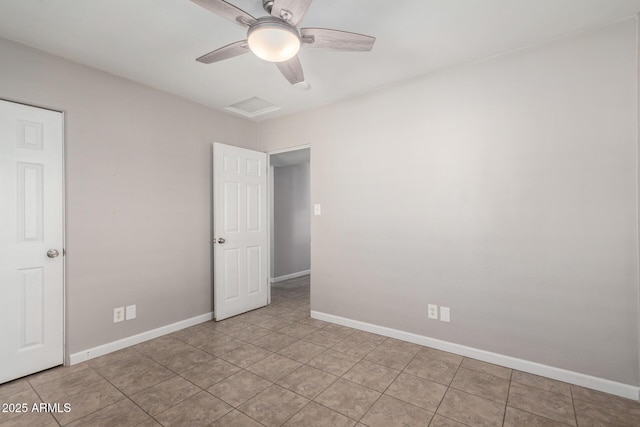 tiled spare room featuring ceiling fan