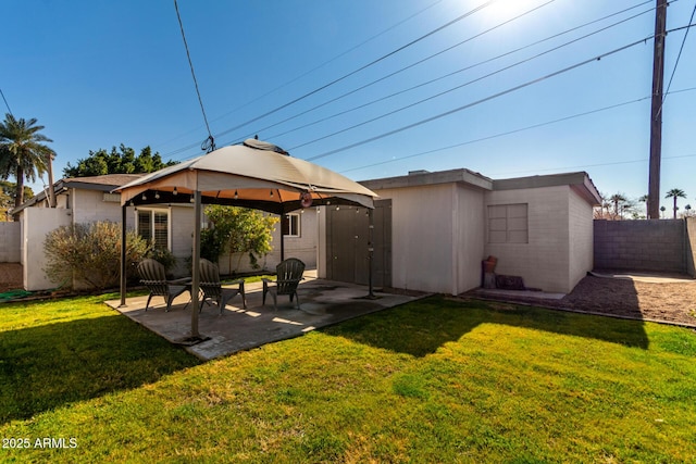 back of house with a gazebo, a lawn, and a patio