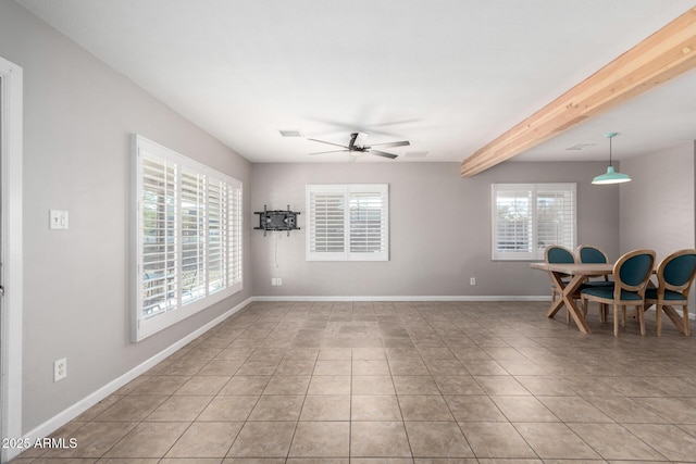 tiled dining room with a wealth of natural light, beamed ceiling, and ceiling fan