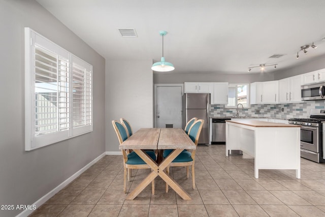 tiled dining room with sink