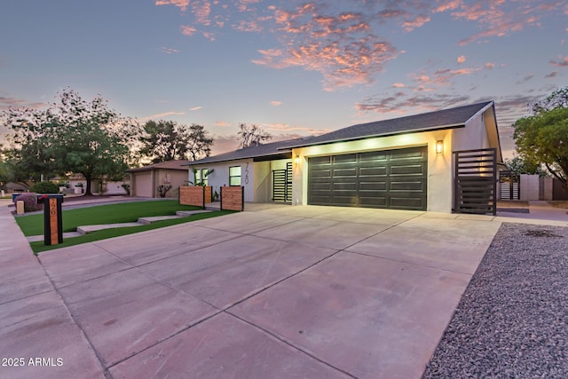 720 E Chilton Dr, Tempe, AZ 85283 - view of front of home with an attached garage, concrete driveway, stucco siding, stairway, and a gate