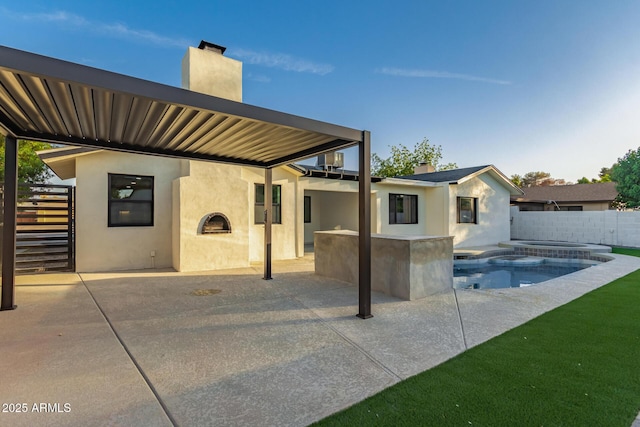 720 E Chilton Dr, Tempe, AZ 85283 - back of house featuring stucco siding, a patio area, a chimney, and a pool with connected hot tub