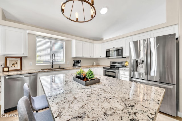 18644 N 21st St, Phoenix, AZ 85024 - kitchen featuring appliances with stainless steel finishes, a sink, white cabinetry, light stone counters, and vaulted ceiling
