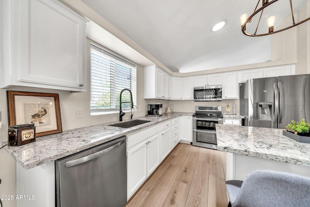 18644 N 21st St, Phoenix, AZ 85024 - kitchen with appliances with stainless steel finishes, a sink, light wood-style flooring, white cabinetry, and light stone countertops