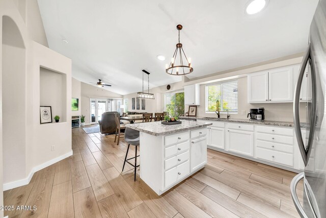 18644 N 21st St, Phoenix, AZ 85024 - kitchen featuring freestanding refrigerator, lofted ceiling, a kitchen island, a sink, and open floor plan