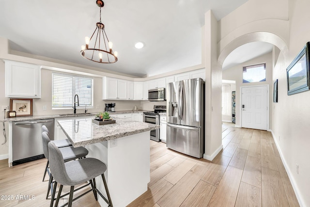 18644 N 21st St, Phoenix, AZ 85024 - kitchen with stainless steel appliances, a sink, a chandelier, a breakfast bar, and a kitchen island