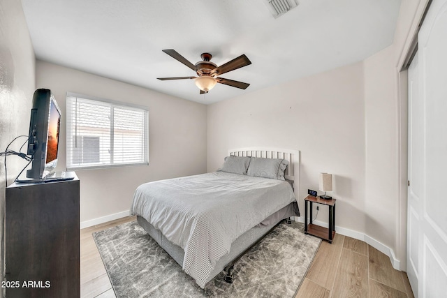 18644 N 21st St, Phoenix, AZ 85024 - bedroom with baseboards, light wood-style floors, a closet, and a ceiling fan
